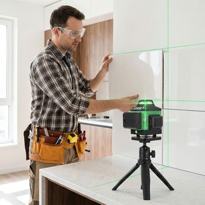 Professionnel avec ceinture outils et niveau laser): "Artisan professionnel avec ceinture outils utilisant niveau laser vert 360° - travaux menuiserie précision