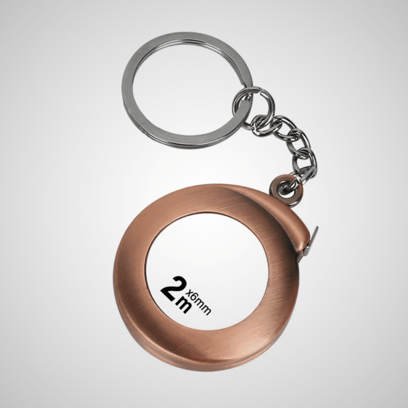 Ruban mètre porte-clés 2m x 6mm – boîtier rond coloris bronze, chaîne argentée, fond gris